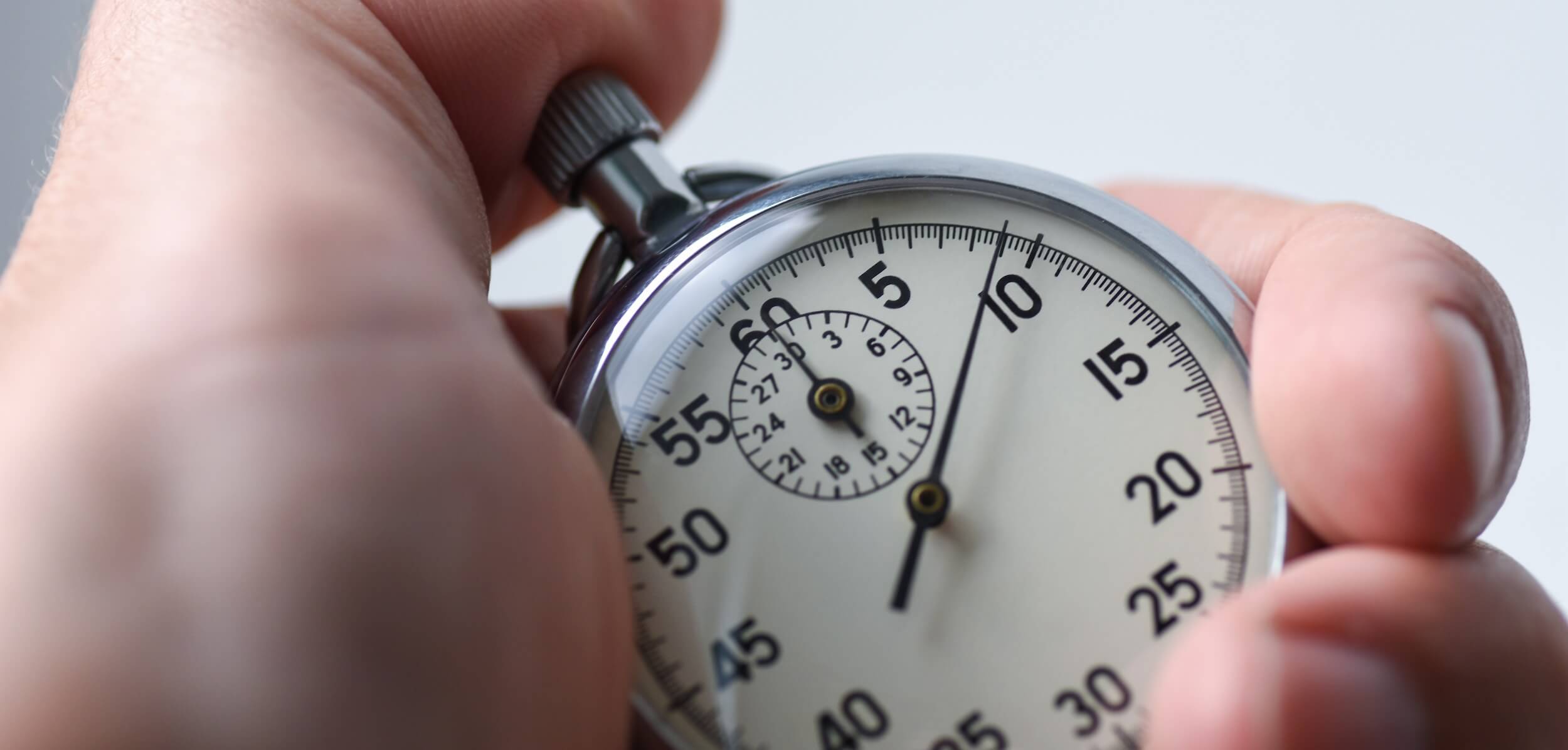 close-up of an isolated hand presses a stopwatch